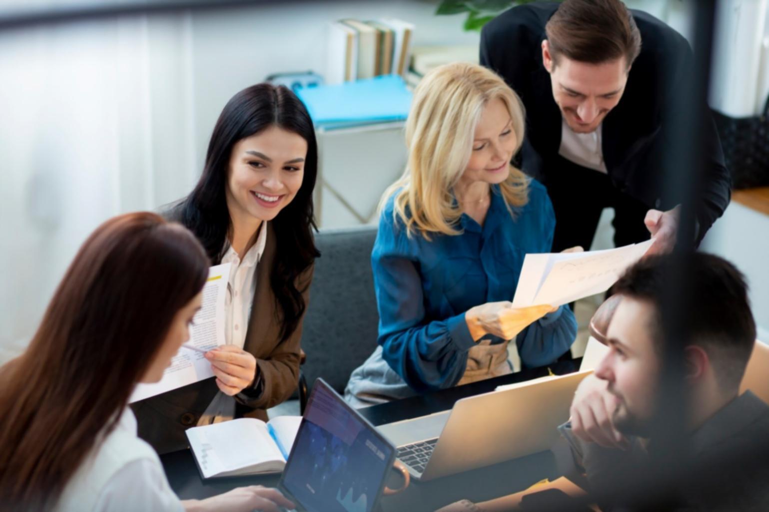 Group of professionals collaborating in a modern learning environment